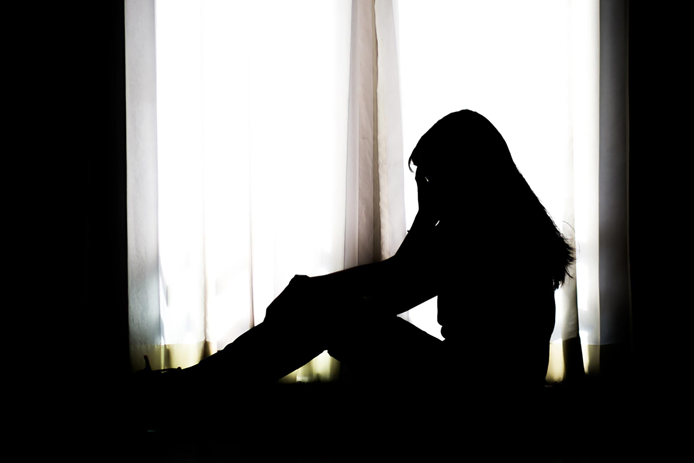 silhouette of a woman in a window