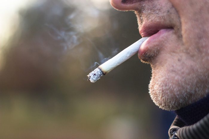 man smoking a cigarette