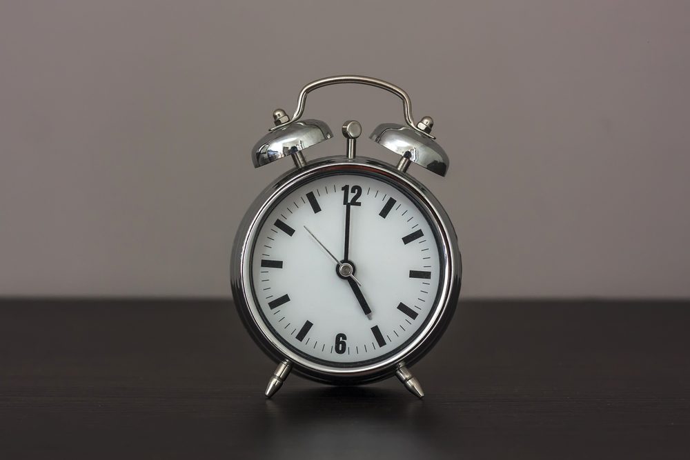 Alarm clock set at five.