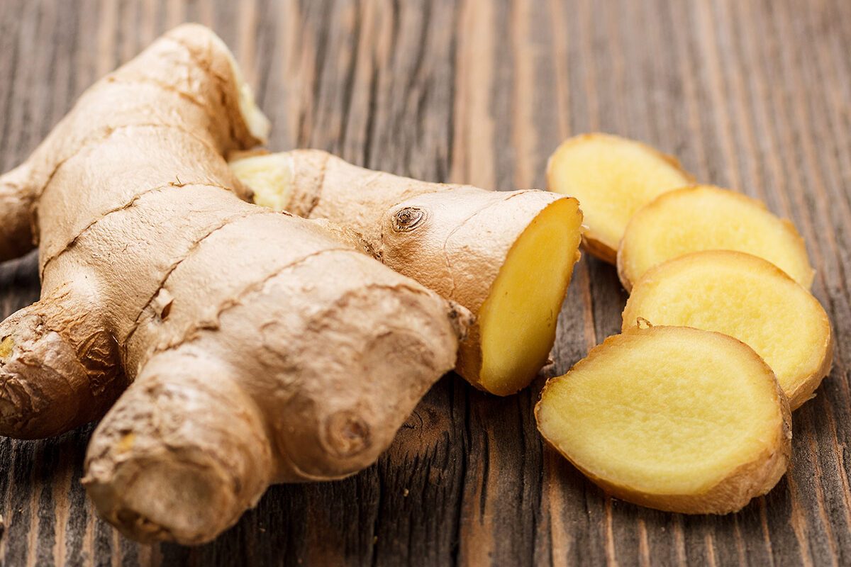 Ginger root sliced on wooden table; Shutterstock ID 127542449