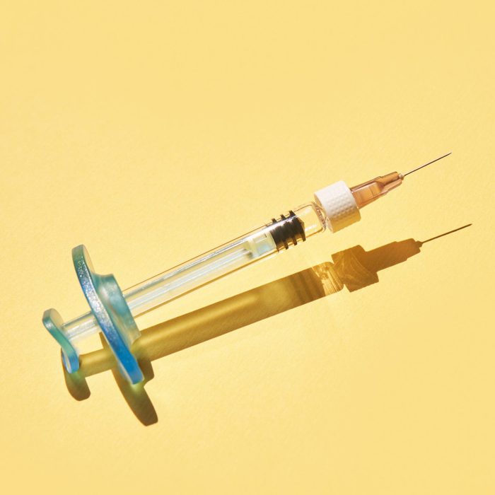 Syringe drug. Doctor injection vaccine. Hard shadow. Healthcare therapy