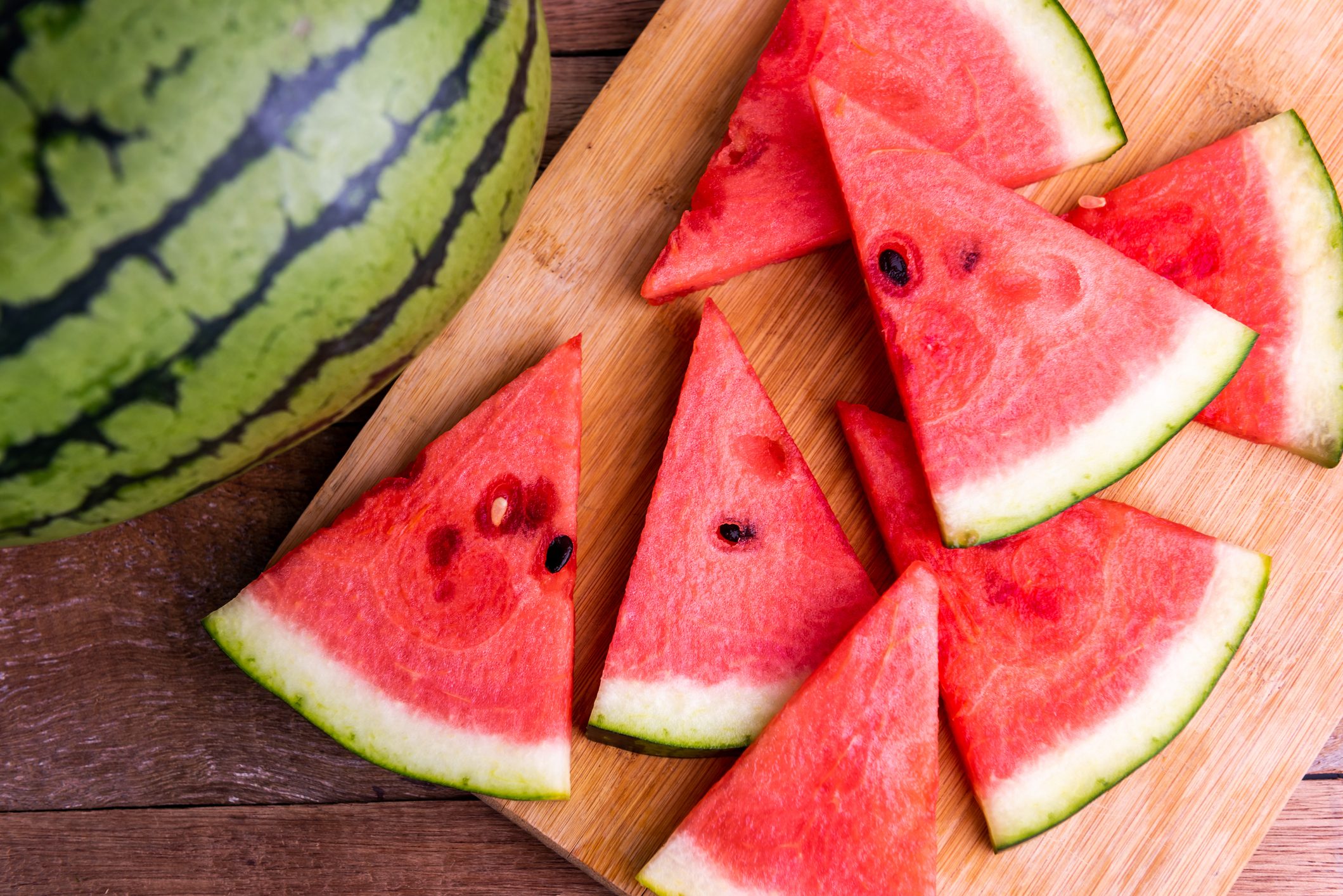 Fresh ripe watermelon slices on wooden table.
