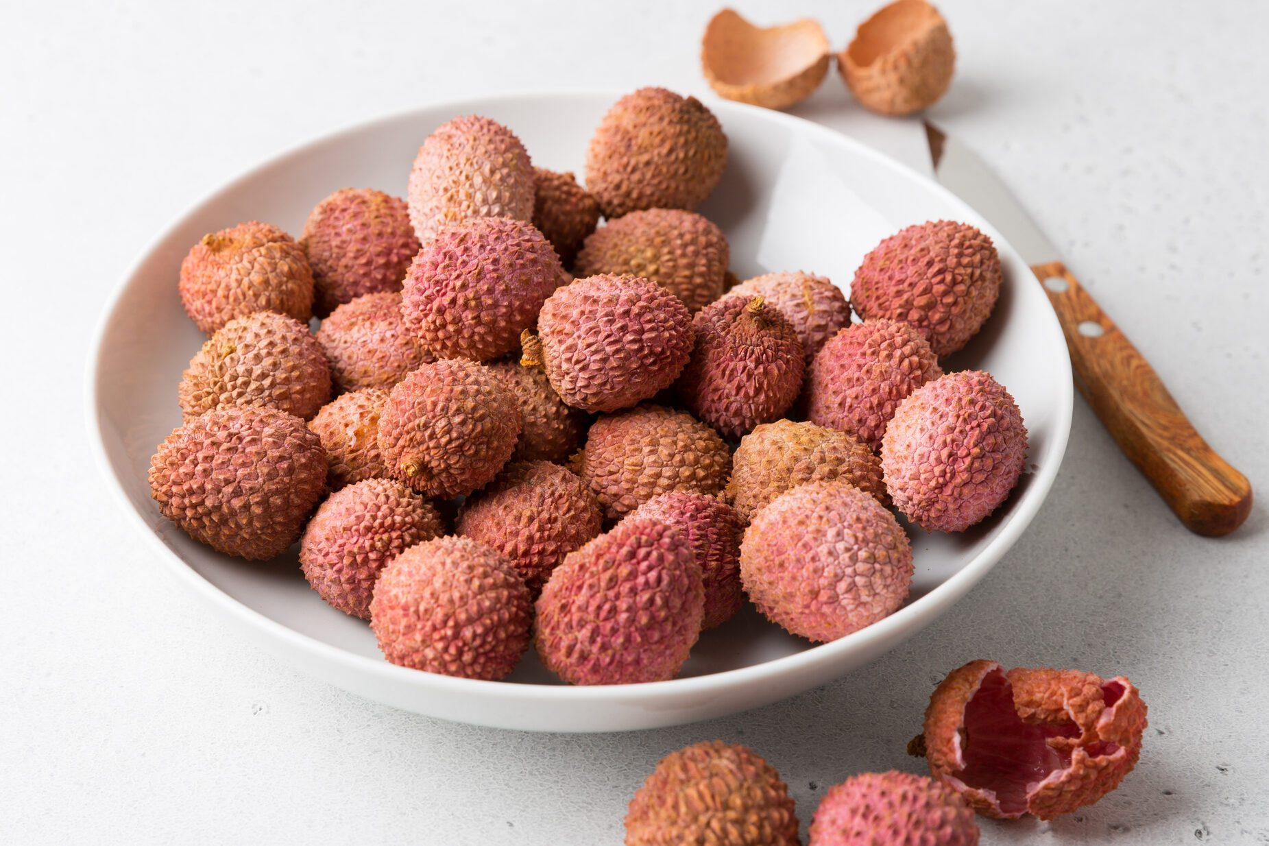 Lychee fruit on a light background.