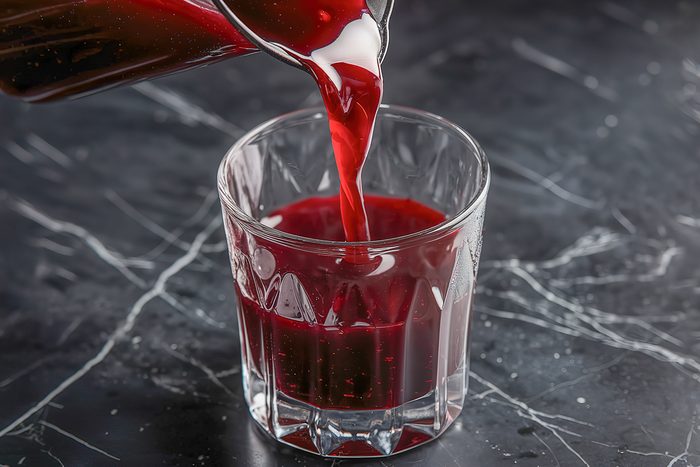 cherry juice being poured into a glass