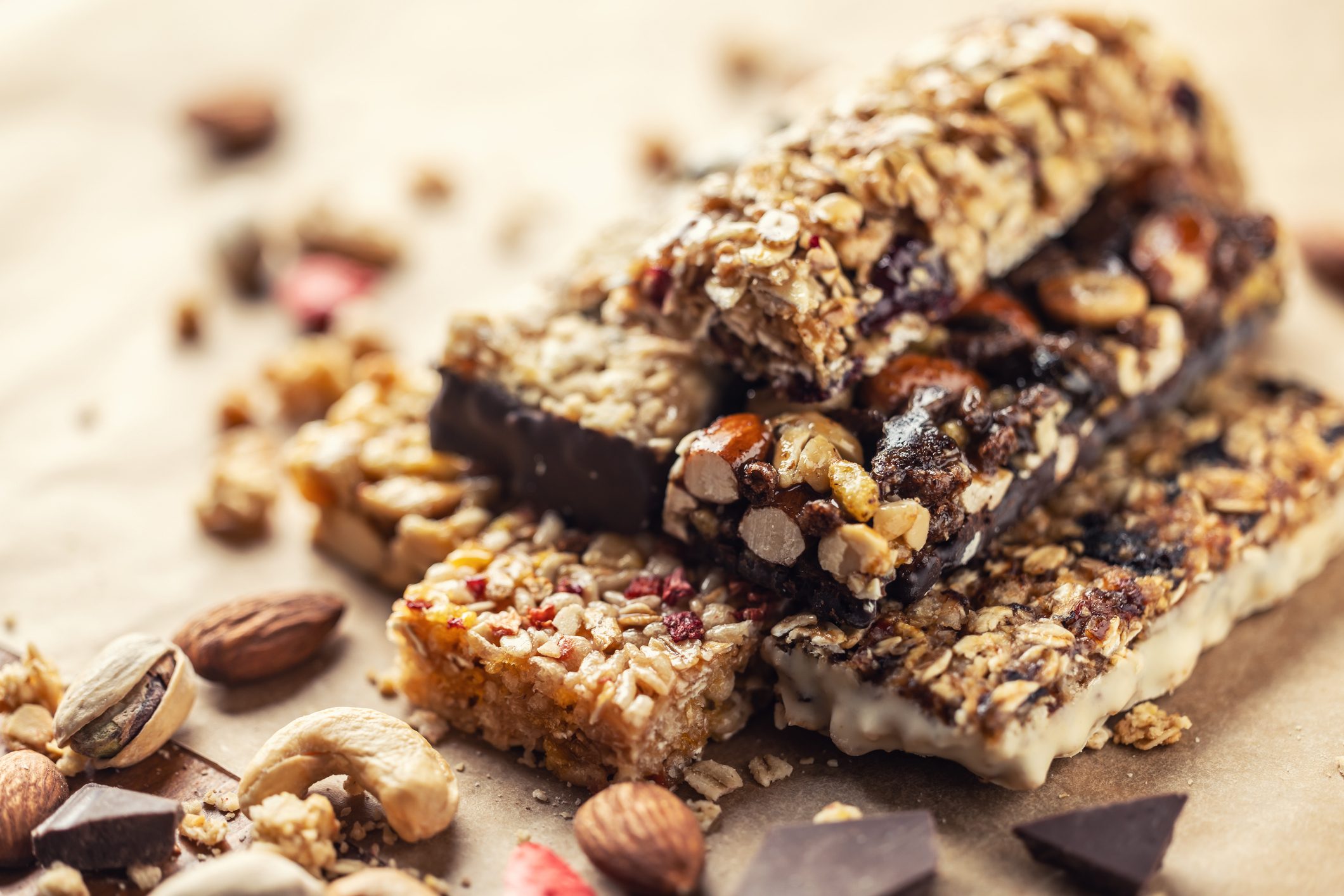 Different Energy protein bars and oatmeal bars on baking paper. Set of energy, sport, breakfast and protein bars.