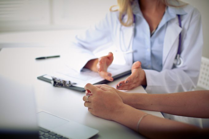 Doctor And Patient Are Discussing Something, Just Hands At The Table