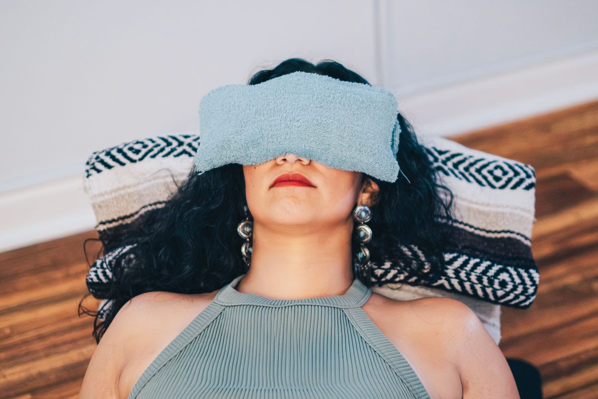 Young Woman Using Warm Compress On Eyes